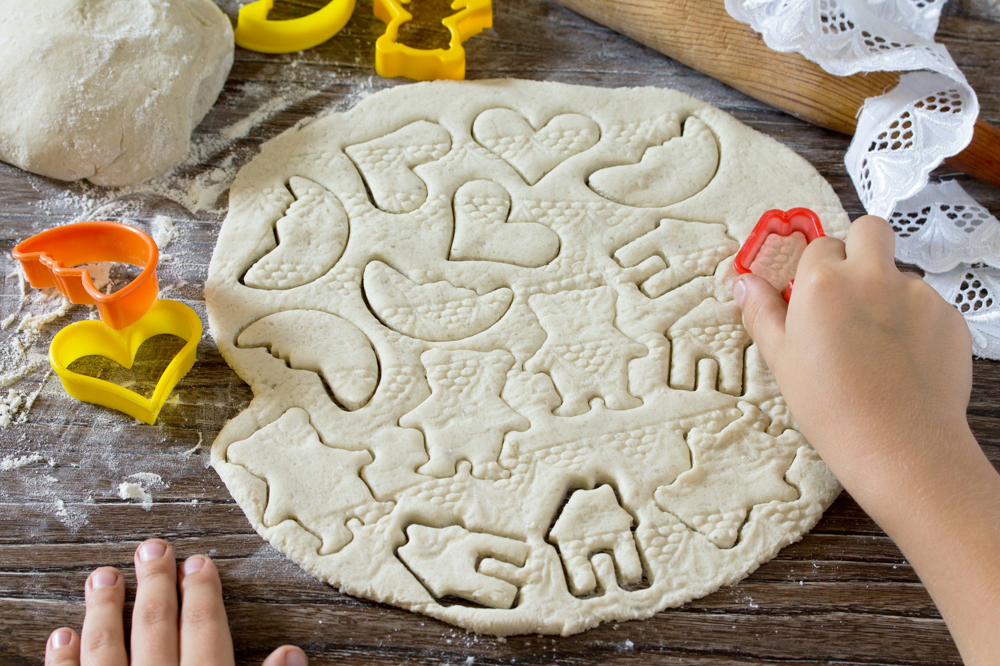 Child sculpts Christmas decorations from salt dough. Children's art project, a craft for children.